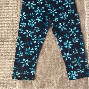 Black pants with blue flowers on it
